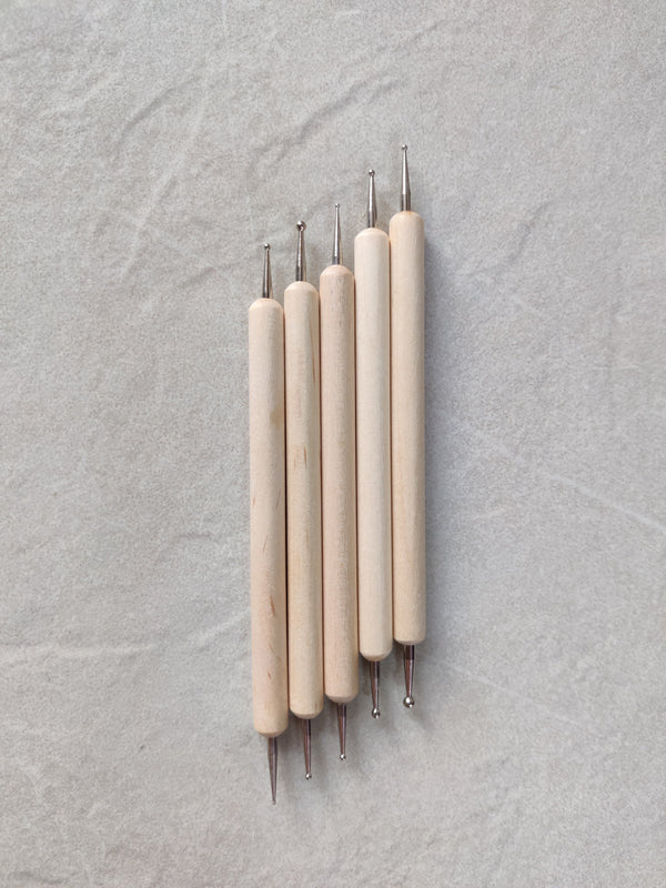 A set of five wooden dotted tools comes with different tip sizes